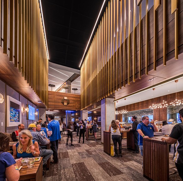 People sitting at tables in a large building.